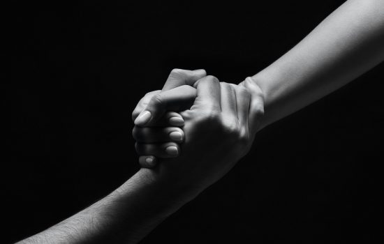 Unrecognizable woman hand helping man to stand up Unrecognizable woman hand helping man to stand up